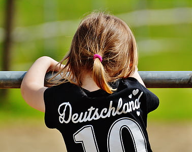 child wearing black T-shirt while holding on bar thumbnail