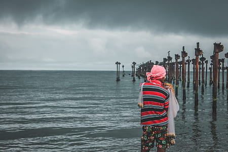 man standing near seashore thumbnail