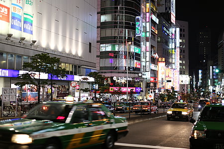 people walking near building at nighttime thumbnail