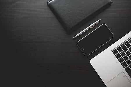 black iPhone 7 with click pen and leather case thumbnail