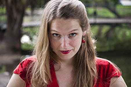 selective focus photo of woman wearing red top thumbnail