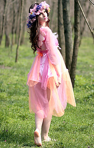 woman wearing pink and orange long-sleeved dress with floral headdress thumbnail