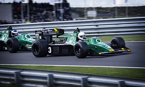 two green F1 cars racing on track thumbnail
