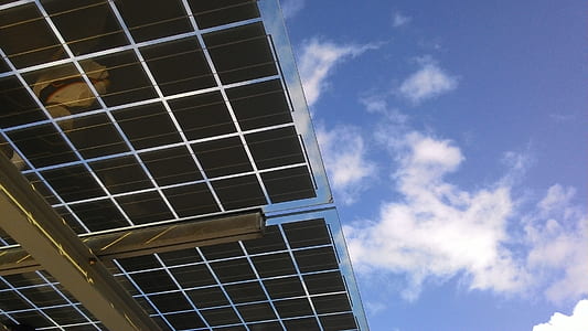 worm's-eye view photography of solar panel under cloudy sky thumbnail