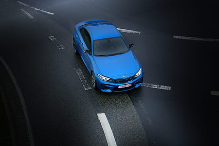 blue BMW car traveling black asphalt road thumbnail