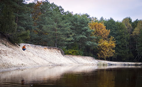 Person Seated Facing Body of Water thumbnail