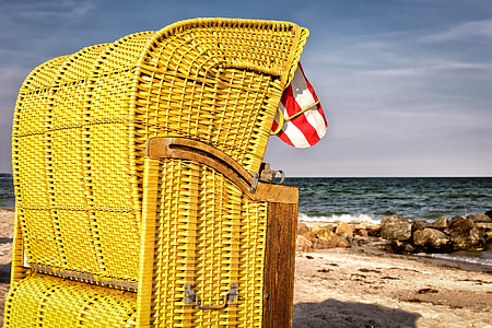 yellow wicker basket near wide ocean at daytime thumbnail