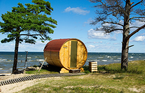 brown wooden barrel-themed house near tree thumbnail