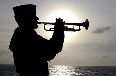 silhouette photography of navy blowing trumpet thumbnail