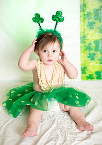 toddler wearing green tutu skirt and yellow necklace thumbnail