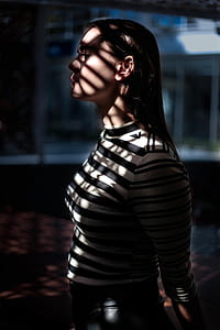 side-view photo of woman wearing white and black stripe long-sleeved top thumbnail