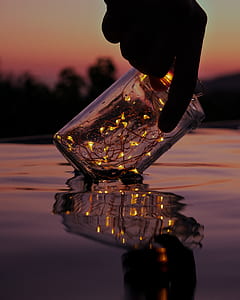 person holding of clear glass jar thumbnail
