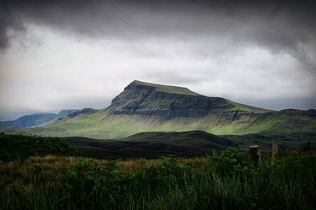 brown mountain cover by green grass under white clouds thumbnail