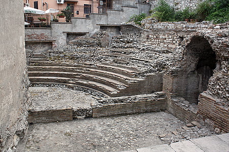 brown and gray concrete ruins near brown building at daytime thumbnail