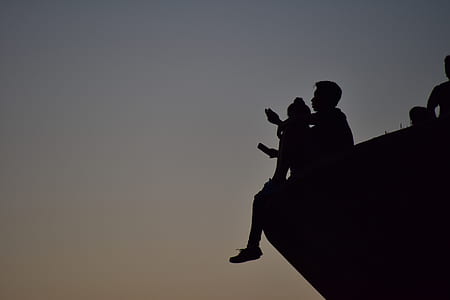silhouette of boy sitting on an edge thumbnail