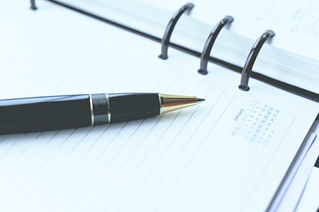close-up photography of black pen top of white notebook thumbnail