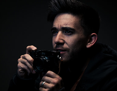 man holding camera thumbnail