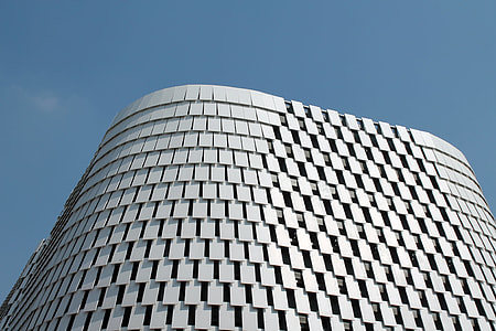 white concrete high-rise building under blue sky thumbnail