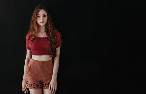 woman in front of black background posing thumbnail