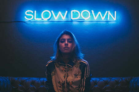 woman wearing adidas jacket sitting on sofa thumbnail