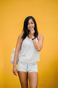 Woman Wearing White Sleeveless Shirt And White Denim Shorts thumbnail