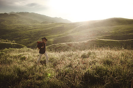 man standing on field during daytime thumbnail