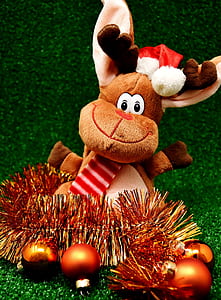 brown reindeer plush toy on green surface thumbnail
