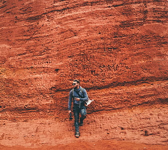 Person Leaning on Brown Wall thumbnail