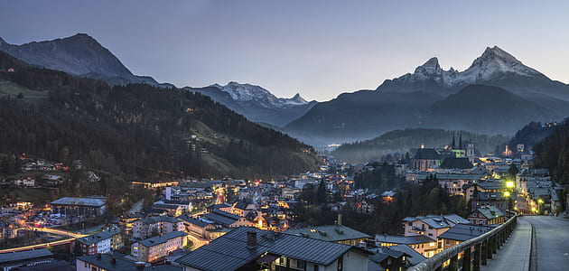 high angle photo of town buildings and mountain under dim sky thumbnail