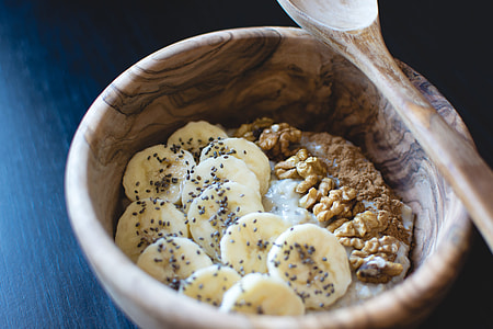 brown wooden bowl with banana slice and oaks thumbnail