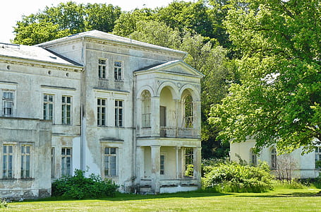 grey and white 3-storey building near green grass during daytime thumbnail