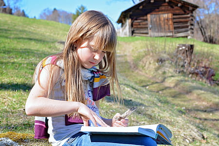 girl reading book outdoor thumbnail