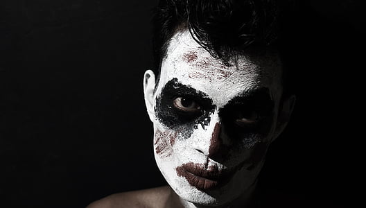 close-up photo of man face with white and red paints thumbnail