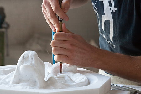 person molding a sculpture thumbnail