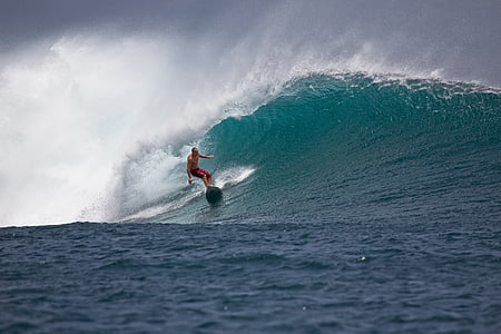 man riding on surfboard thumbnail