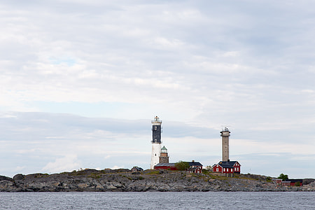 two lighthouse near body of water under white clouds thumbnail