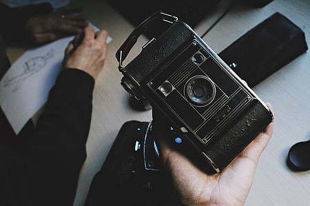person holding black vintage camera thumbnail