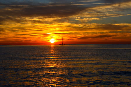 boat sailing on water under golden hour thumbnail