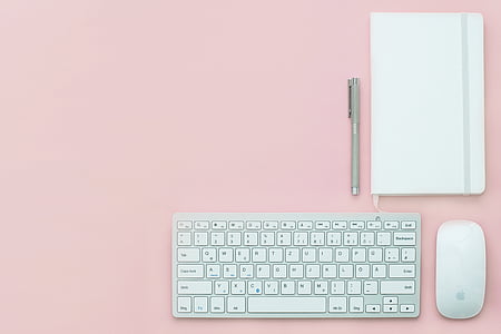 gray cordless keyboard beside Apple Magic Mouse thumbnail