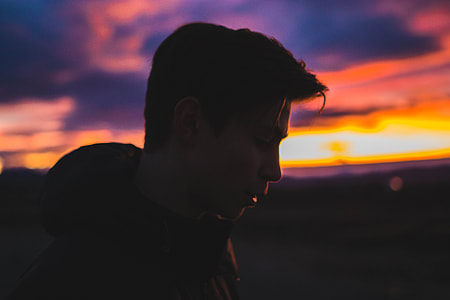 silhouette of man in hooded jacket thumbnail