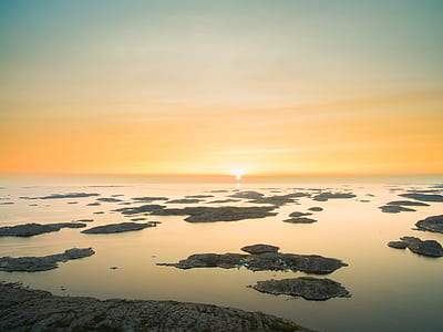 landscape photography of water near land thumbnail