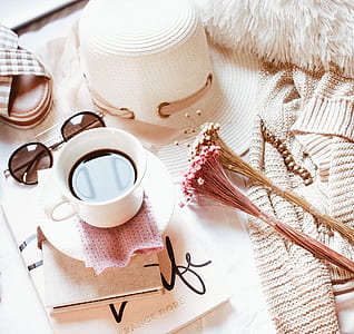 white teacup with saucer near sunglasses thumbnail