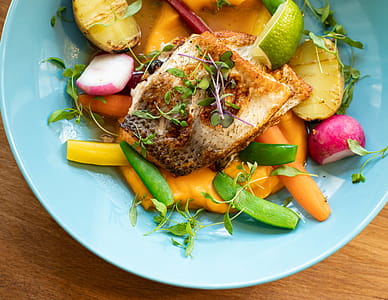 Fried Fish With Vegetables Dish on Teal Plate thumbnail