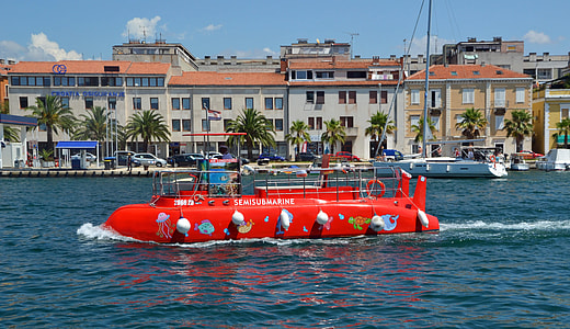 red rescue boat across white concrete houses thumbnail