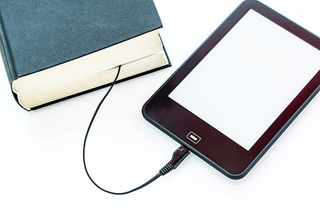 black tablet computer and blue book thumbnail
