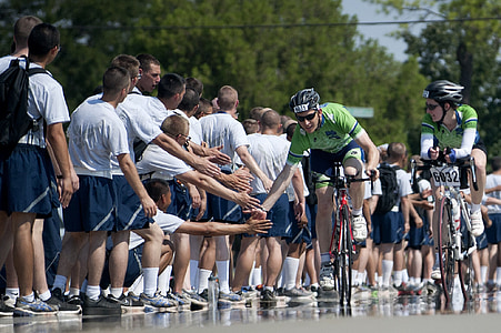 people watching bicycle riders on street during daytime thumbnail