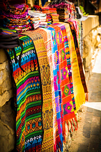 selective focus photo of assorted-color scarves on gray concrete wall thumbnail