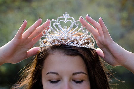 woman holding crown on head thumbnail