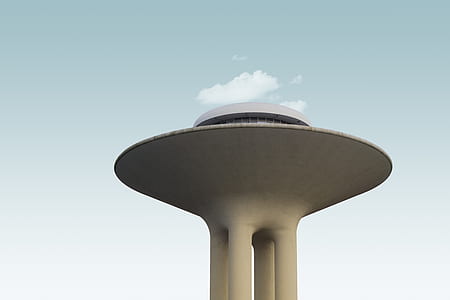 white concrete tower under green sky thumbnail
