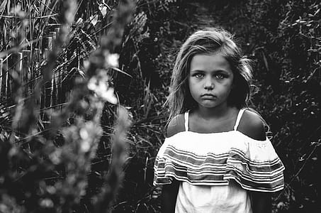girl wearing dress standing in field thumbnail